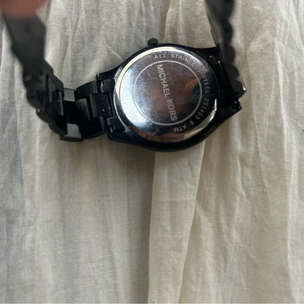 Michael Kors Black and Gold Watch It needs a battery replacement.